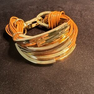 Multi-strand (20 strands) Cord and Gold tone Metal Bracelet.